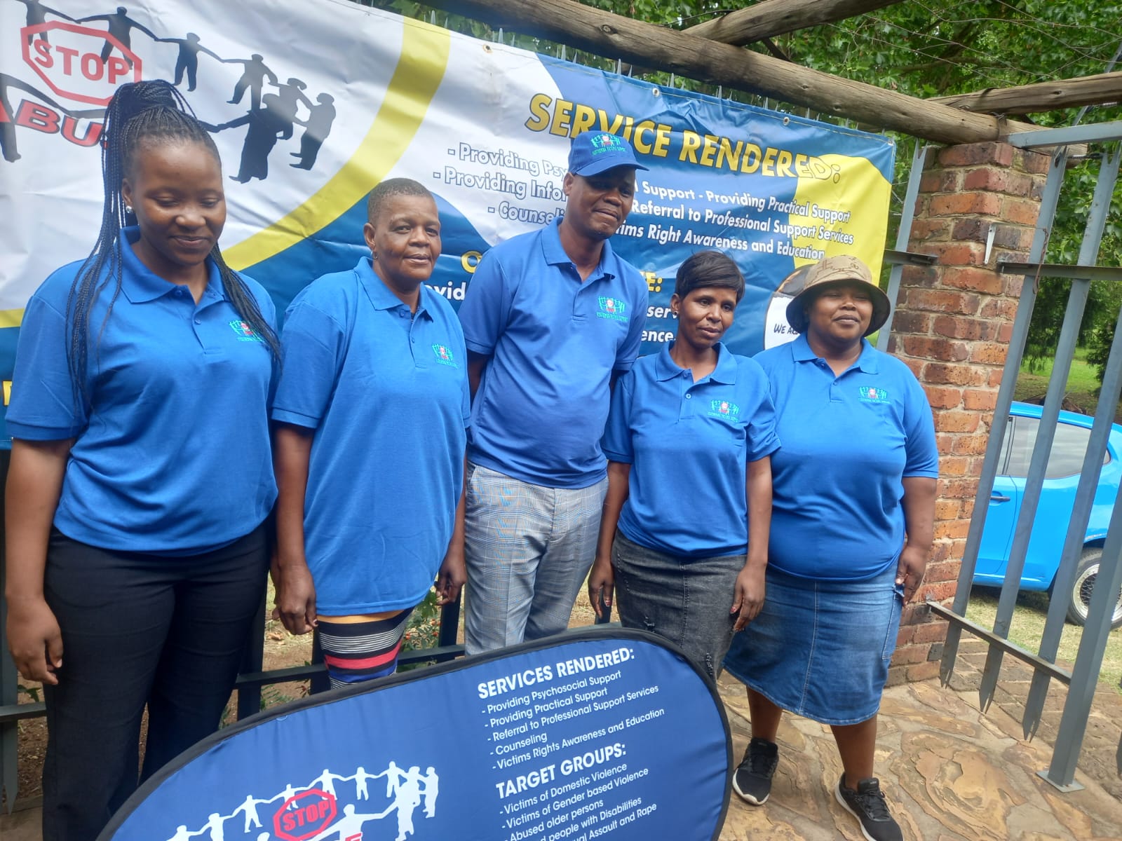 Staff members presenting victim support services outdoors