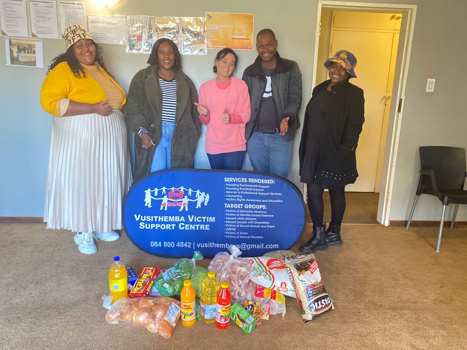 Vusithemba team with partner visitors and donated supplies